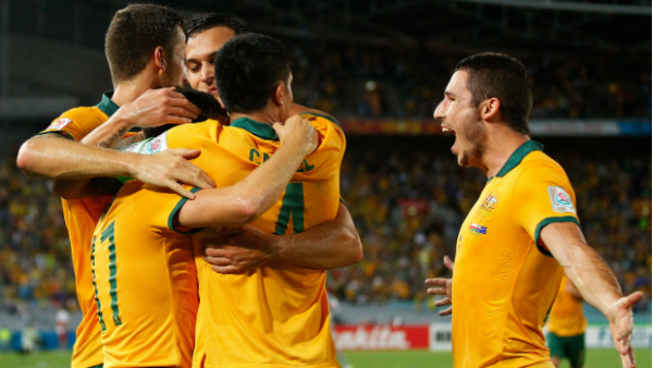 The Socceroos celebrate Matt McKay's opener against Oman.