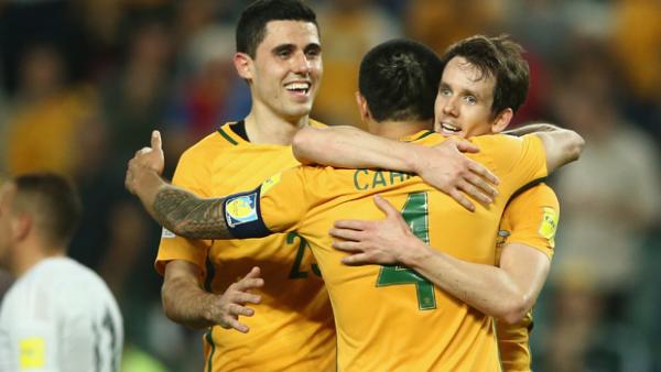 Socceroos Tim Cahill, Robbie Kruse and Tom Rogic celebrate a goal against Jordan.