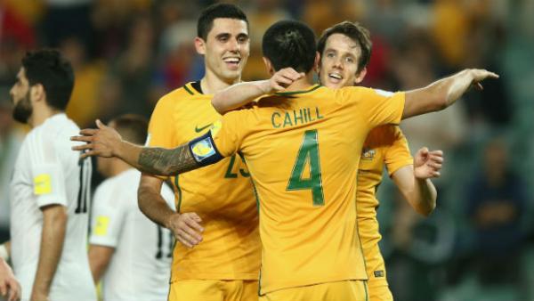 Socceroos Tim Cahill, Tom Rogic and Robbie Kruse celebrate opening the scoring against Jordan on Tuesday night.
