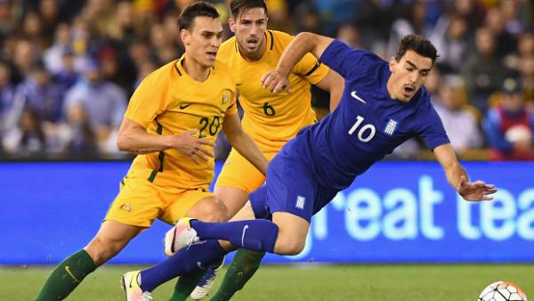 Trent Sainsbury fights for the ball during Australia's 2-1 loss to Greece.