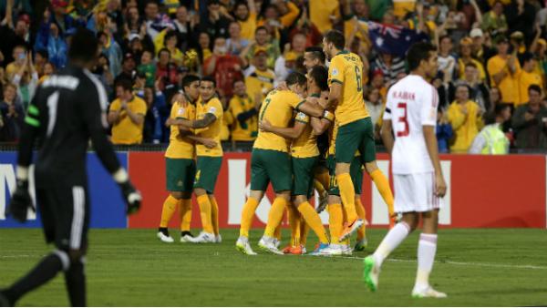 The Socceroos embrace each other after scoring against the UAE.