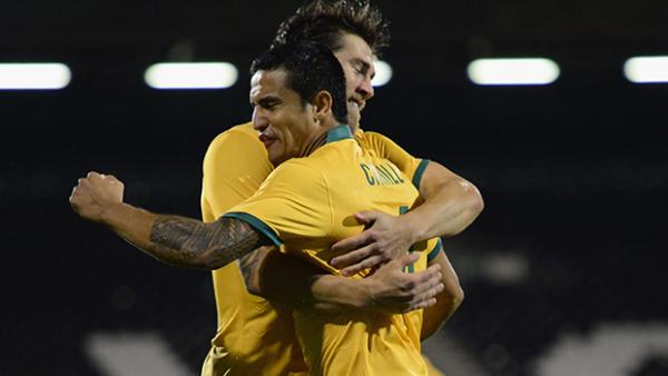 Tim Cahill celebrates with Josh Brillante after opening the scoring against Saudi Arabia.