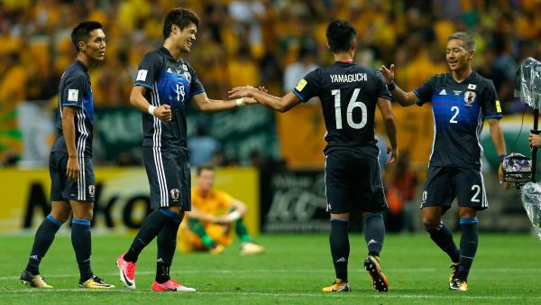 Japanese players celebrate a goal in their 2-0 win over the Caltex Socceroos.