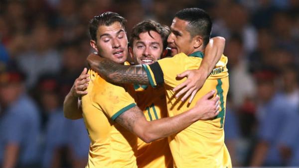 Tommy Oar is embraced by James Troisi and Tim Cahill after scoring the Socceroos second goal.