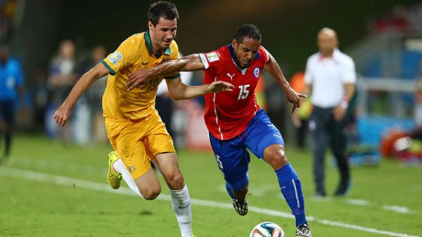 McGowan challenges Chile's Jean Beausejour in Australia's World Cup opener.