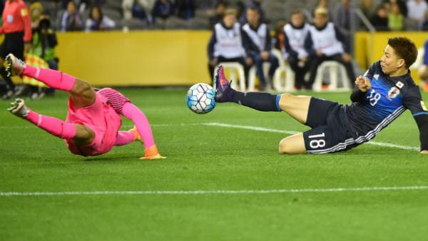 Caltex Socceroos goalkeeper Mat Ryan dives to make a save against Japan.