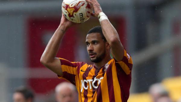 Bradford City defender James Meredith takes a throw-in in the FA Cup.
