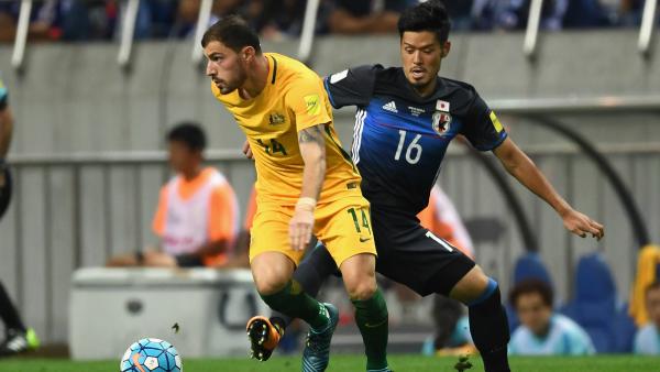 James Troisi looks to wriggle clear of his marker in Australia's 2-0 loss to Japan.