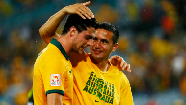 Tim Cahill congratulates Socceroos teammate Tomi Juric after win over Oman.