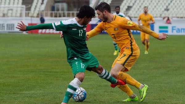 Winger Mat Leckie takes on his Iraqi opponent during the 1-1 draw in Tehran.