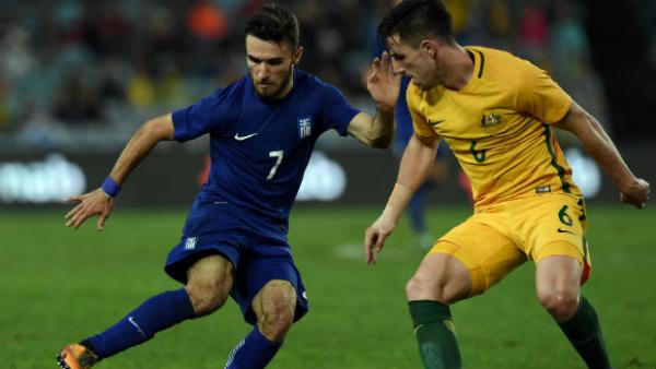 Caltex Socceroos defender Milos Degenek shadows Greece attacker Loannis Gianniotas.