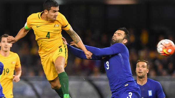Tim Cahill rises for a header during Australia's 2-1 loss to Greece.