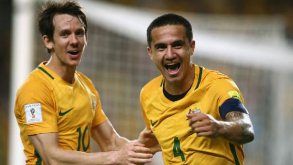 Tim Cahill celebrates opening the scoring against Jordan in Sydney with Robbie Kruse