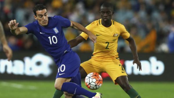 Defender Jason Geria make a challenge on Greek midfielder Lazaros Christodoulopoulos in his Caltex Socceroos debut.